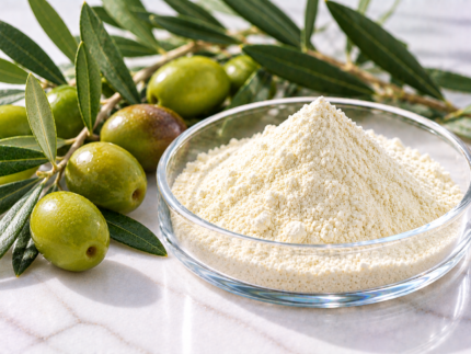 Hydroxytyrosol powder in a glass dish with olives and olive leaves for cosmetic formulations