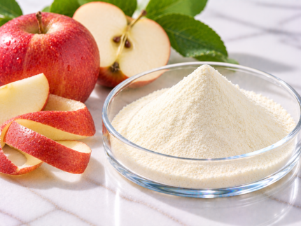 Phloretin pale yellow botanical ingredient powder in a glass dish with fresh apples